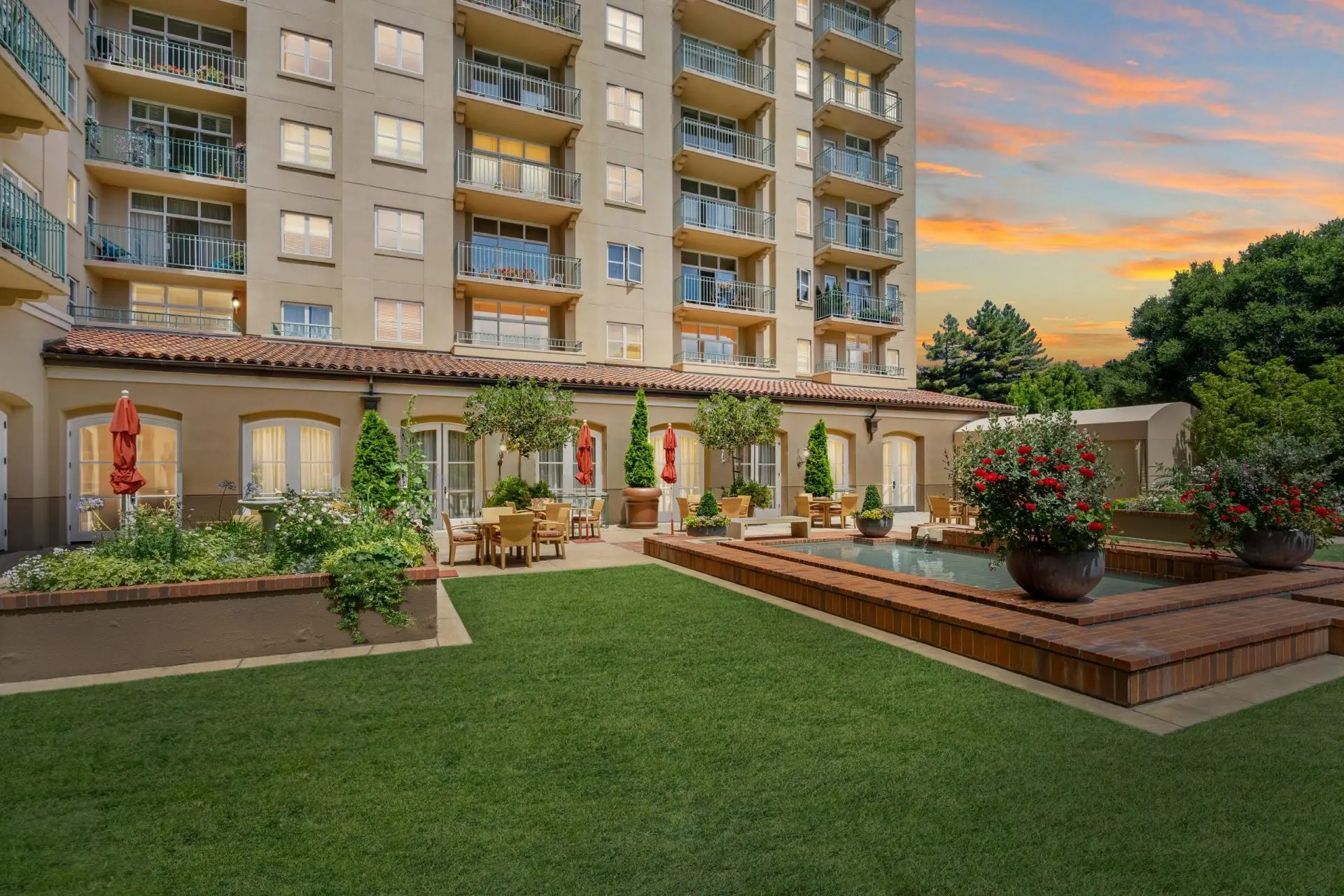 A manicured courtyard and sitting area outside of the senior condos in San Mateo