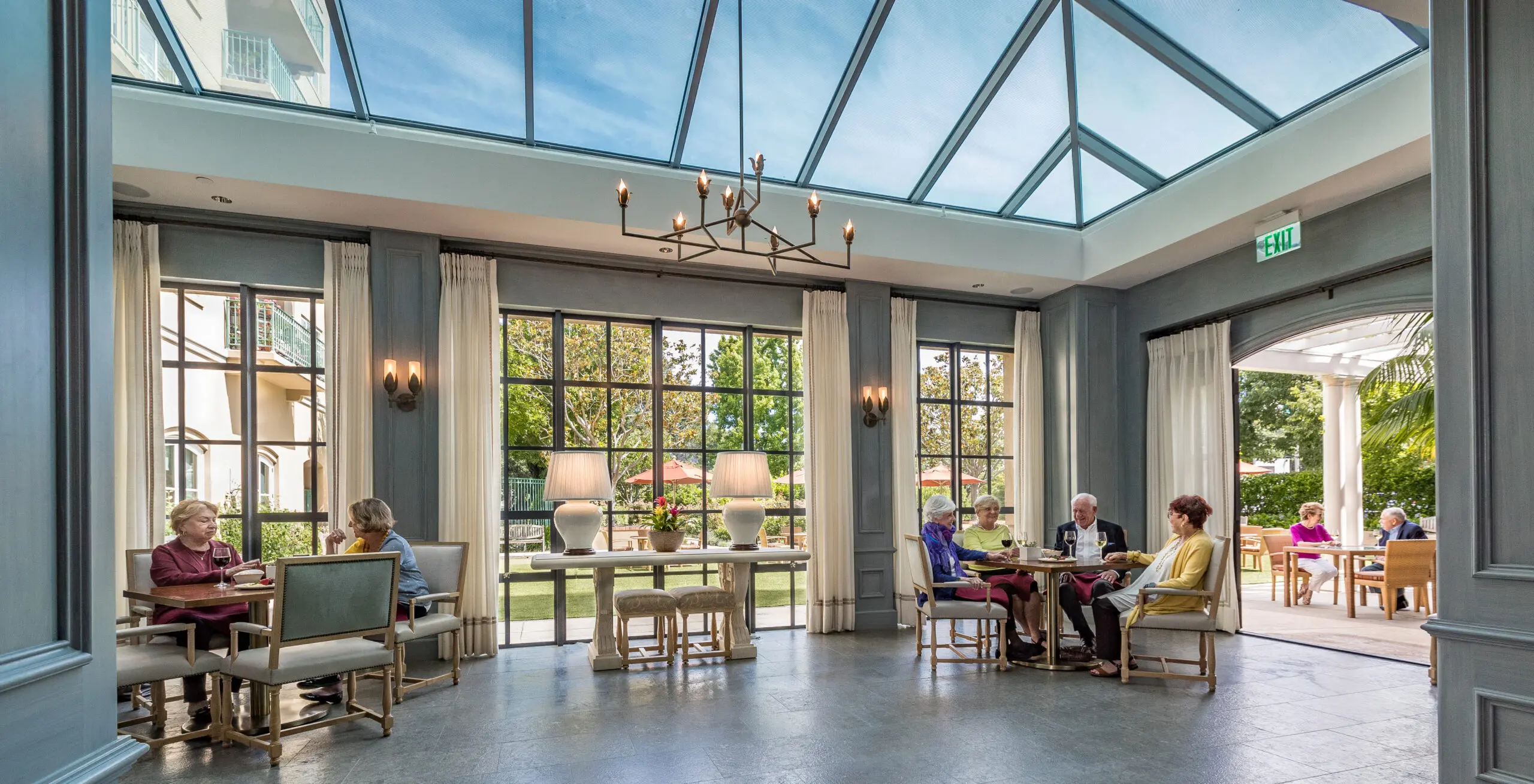 The Peninsula Regent indoor and outdoor atrium, where older adults gather and talk